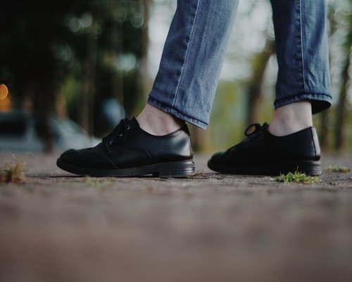 Comfortable shoes stepping on pavement