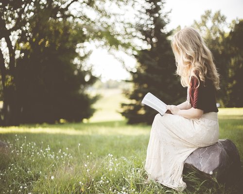 Person sitting comfortably reading a book